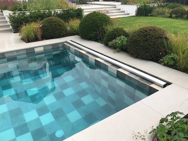 Cover retracted, hidden on pool wall